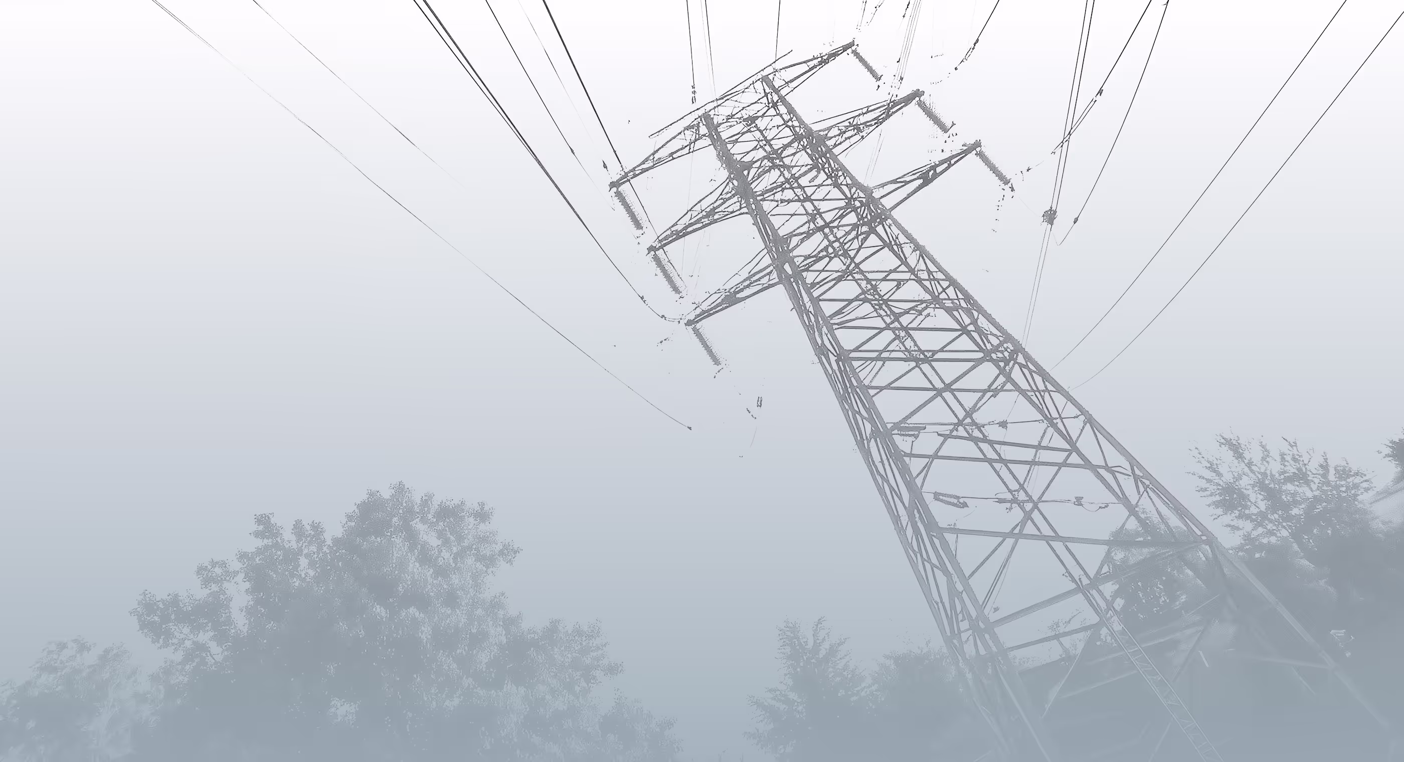 An electricity transmission tower photographed from the air against an overcast sky